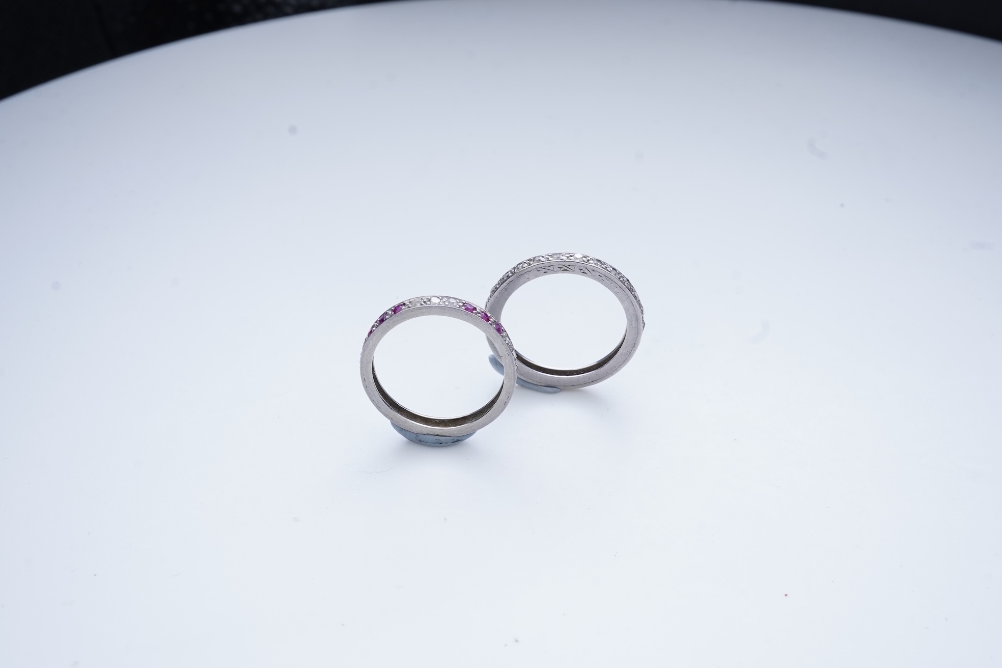 A diamond eternity ring and a ruby and diamond half eternity ring, mid 20th century
